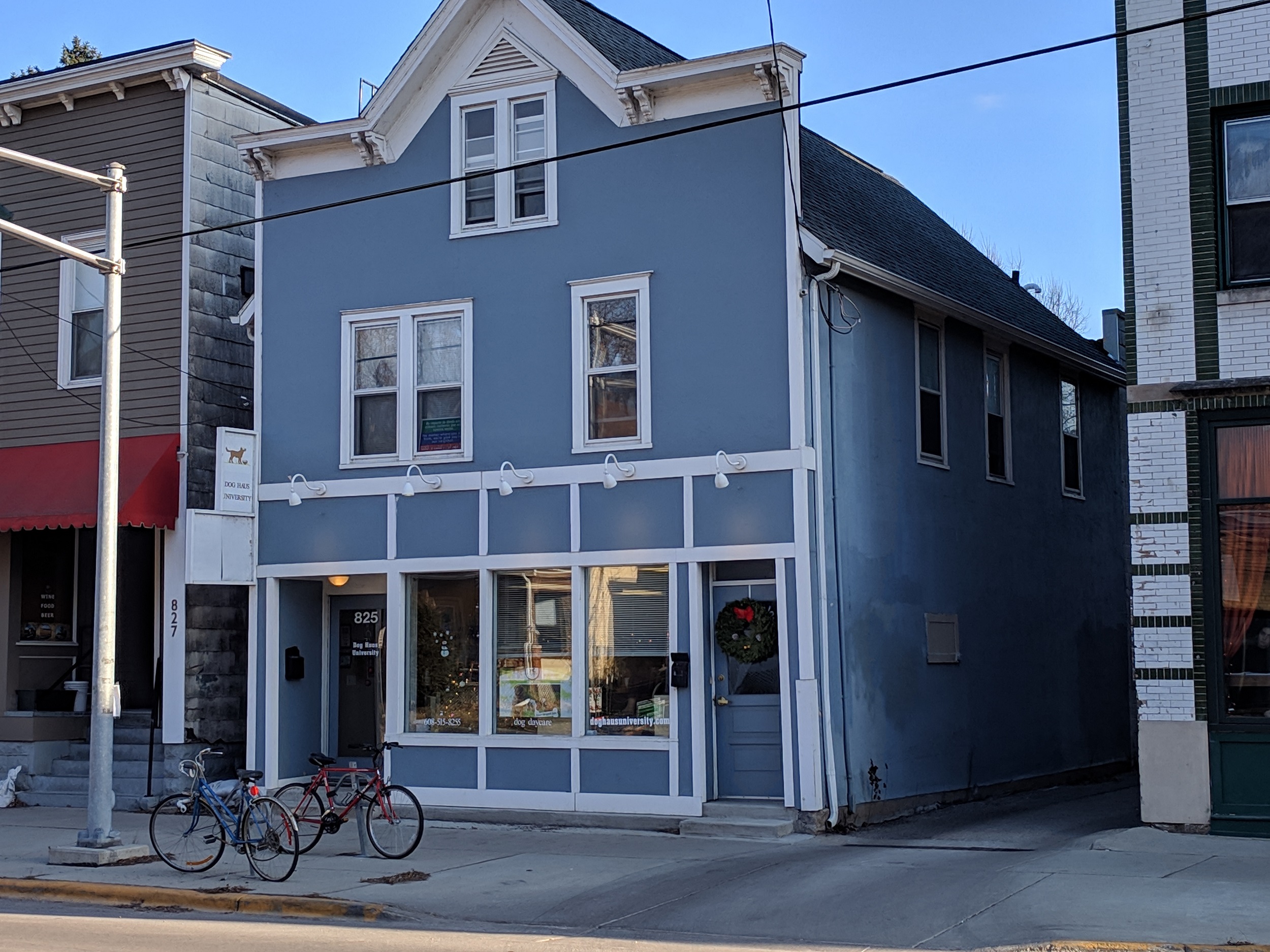 a blue building with bikes parked outside of it on a street